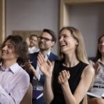 group,of,smiling,businesspeople,welcoming,corporate,trainer,,express,gratitude,to