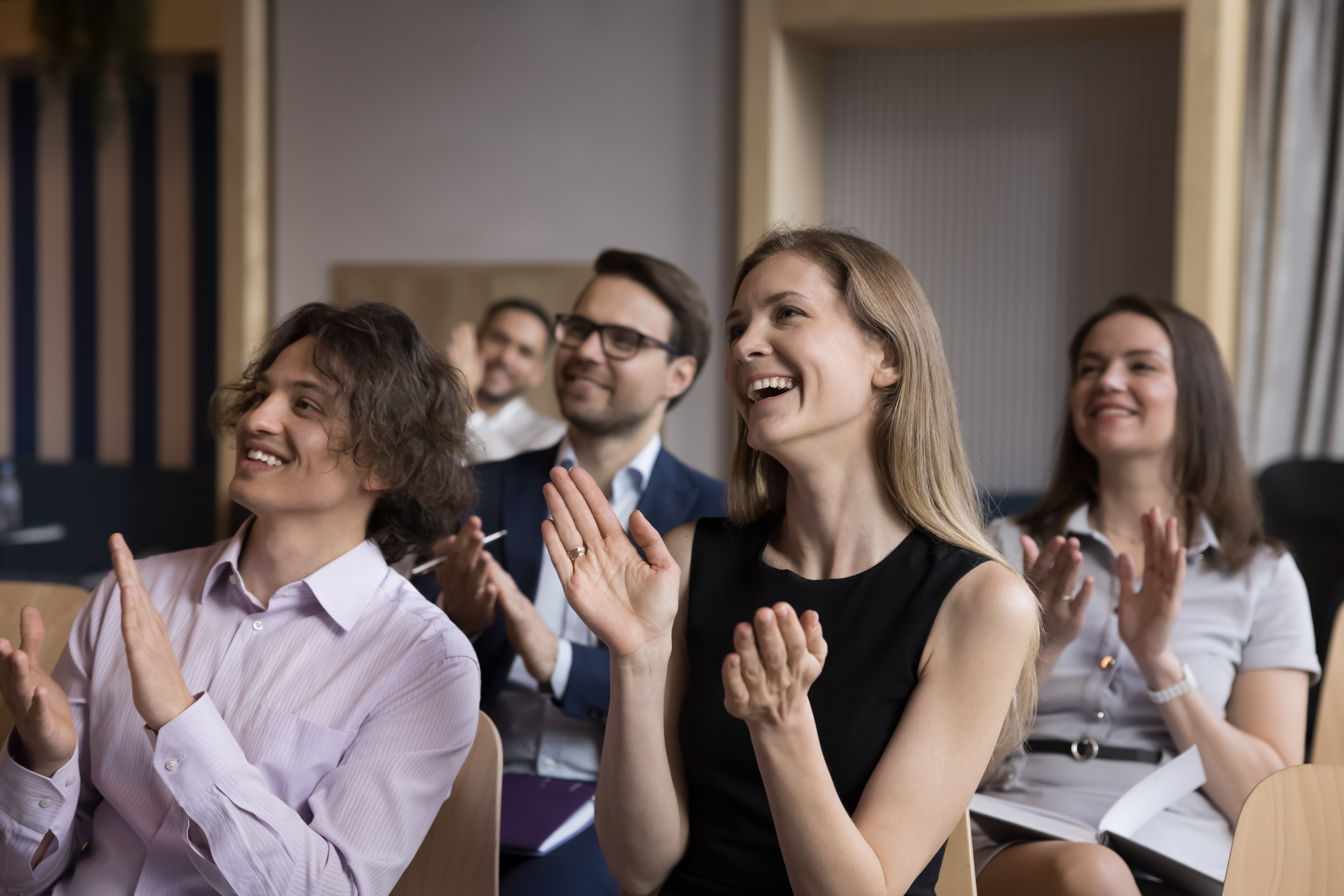 group,of,smiling,businesspeople,welcoming,corporate,trainer,,express,gratitude,to